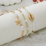 boho_pearl_and_shell_bracelet_wrist-shell bracelet- coastal look-beach style-shell jewerly-seashell jewelry-layered bracelet-cowrie bracelet