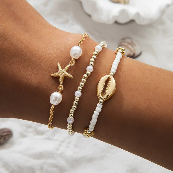 boho_pearl_and_shell_bracelet_wrist-shell bracelet- coastal look-beach style-shell jewerly-seashell jewelry-layered bracelet-cowrie bracelet
