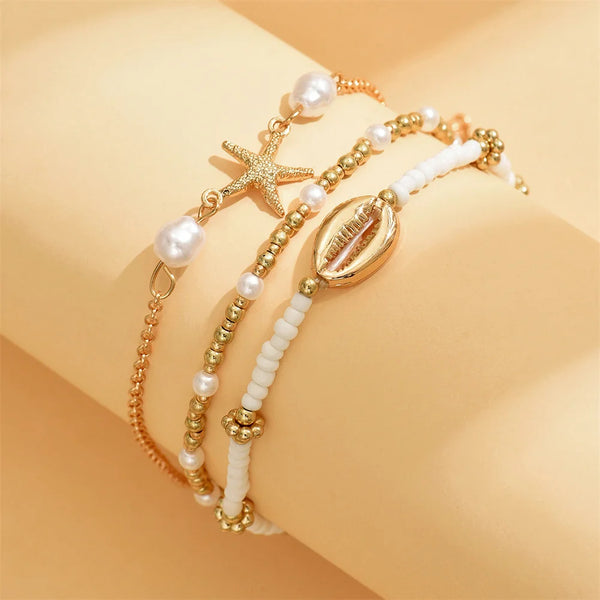 Layered Gold Starfish & Cowrie Shell Anklet Trio