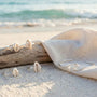 several real Sterling silver rings on white sand beach