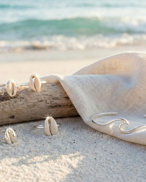 several real Sterling silver rings on white sand beach