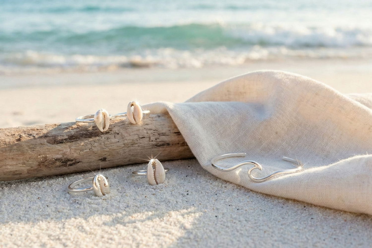 several real Sterling silver rings on white sand beach