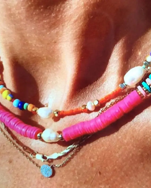What are the benefits of wearing shell necklaces for energy and well-being?