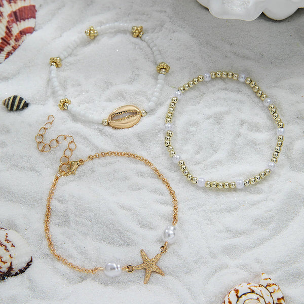 boho_pearl_and_shell_bracelet_wrist-shell bracelet- coastal look-beach style-shell jewerly-seashell jewelry-layered bracelet-cowrie bracelet
