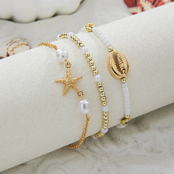 boho_pearl_and_shell_bracelet_wrist-shell bracelet- coastal look-beach style-shell jewerly-seashell jewelry-layered bracelet-cowrie bracelet