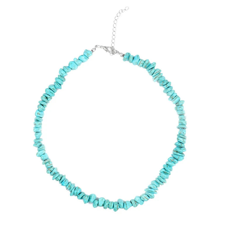 Turquoise beaded  puka shell necklace on a white background