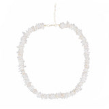 Necklace with white puka shell beads on a white background silver chain