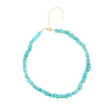 Turquoise beaded necklace on a white background gold chain