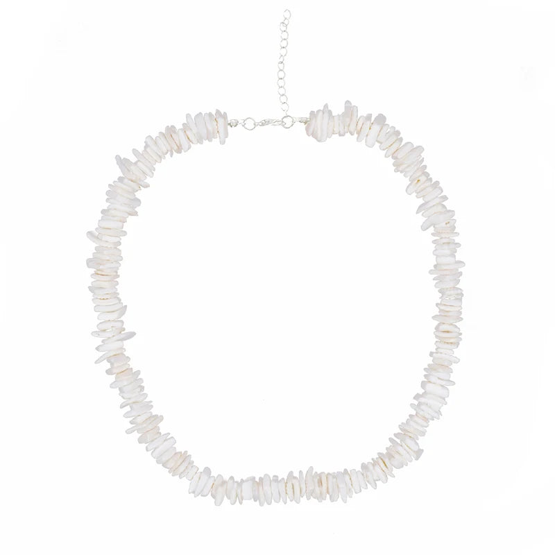 Necklace with white puka shell beads on a white background silver chain