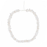 Necklace with white puka shell beads on a white background silver chain