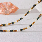 Alt Text 4: Close-up of necklace clasp and extender showcasing shell beads and earthy jasper stones in beach vibes aesthetic.
