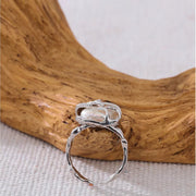 Entwined Pearl silver Ring in front of wood