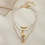 Gold_Starfish_Pearl_Layered_Shel-shell jewelry-boho style-beach outfit-boho chic style-bohemian jewelry-coastal look-beach style
