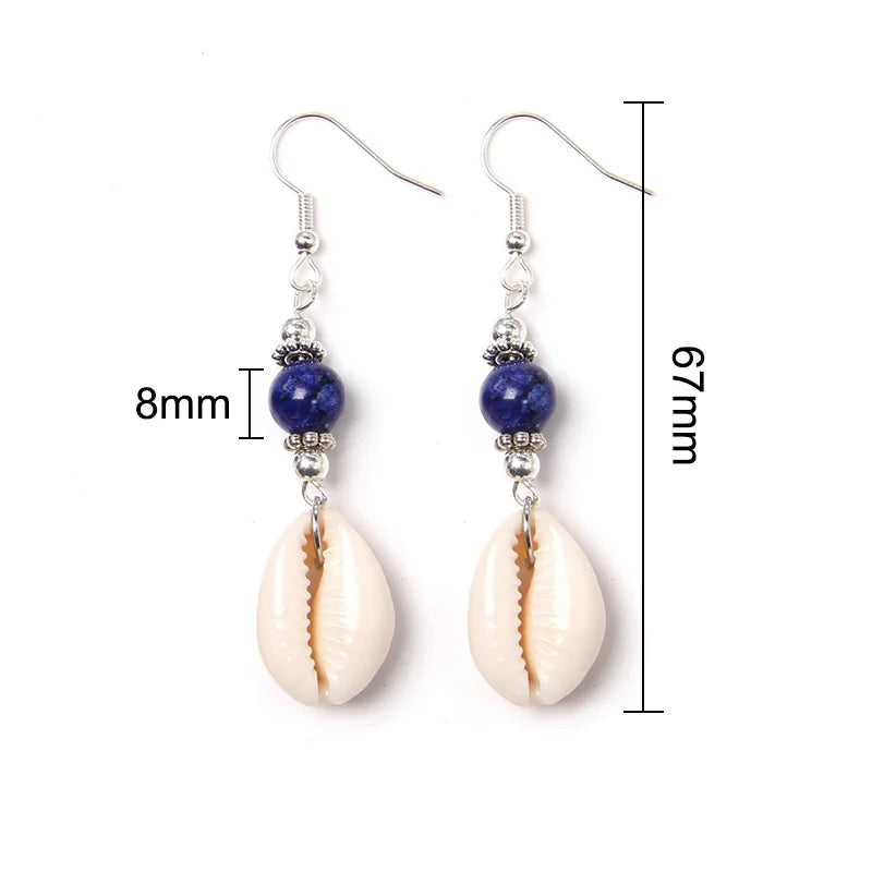 Pair of earrings with cowrie shells and blue beads, shown with measurements on a white background.
