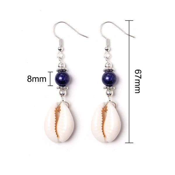 Pair of earrings with cowrie shells and blue beads, shown with measurements on a white background.