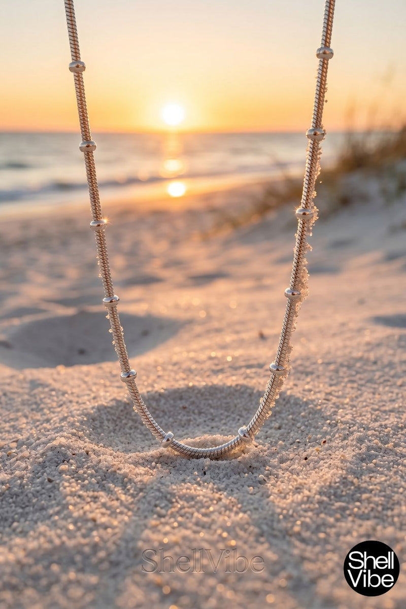 Sterling silver Necklace on sand with sunset in the background