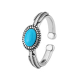 Sterling silver ring with a turquoise stone on a white background