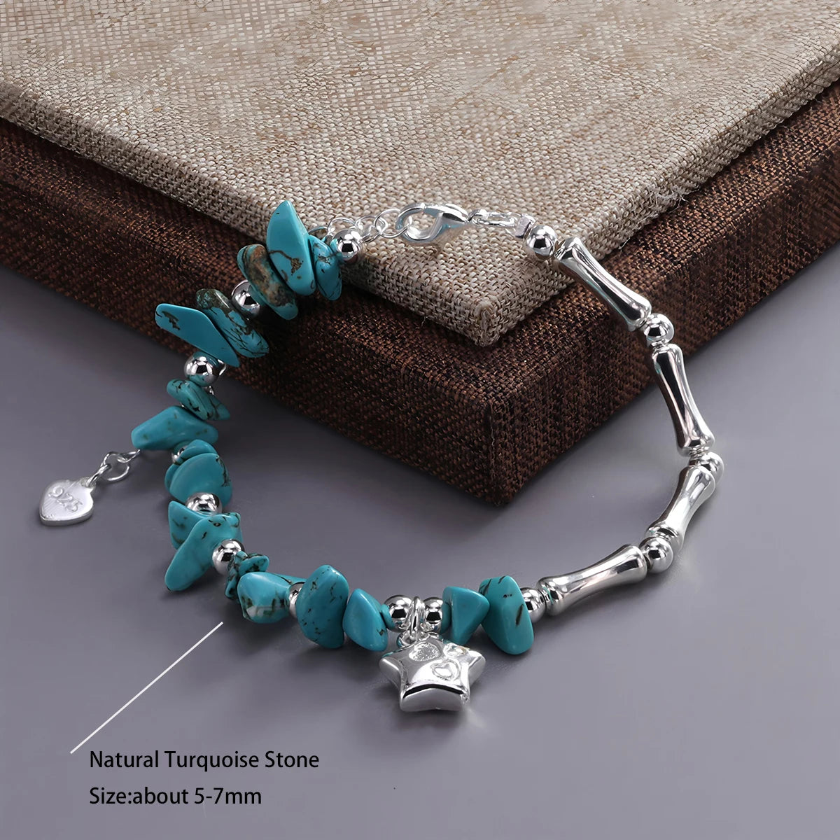 Turquoise stone bracelet with silver accents on a textured surface