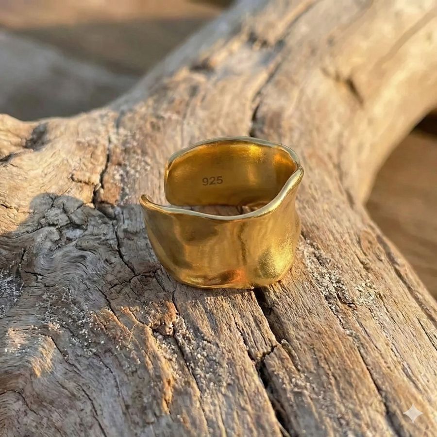 gold sterling silver ring on drift wood
