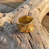 gold sterling silver ring on drift wood
