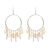 Cowrie Hoop earrings with shell beads on a white background