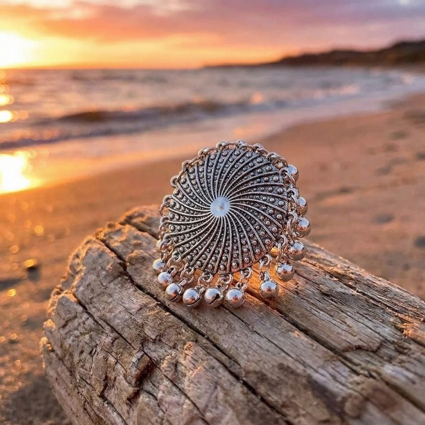 silver plated statement ring on drift wood, beach and sunset background
