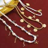 Gold and pearl necklaces , beaded cowries on  a red background