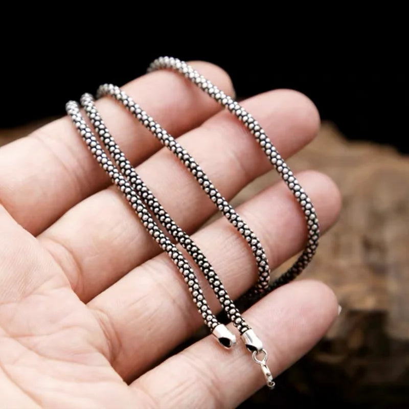 sterling silver necklace in a hand