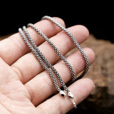 sterling silver necklace in a hand
