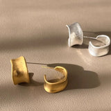 sterling silver hoops on beige surface