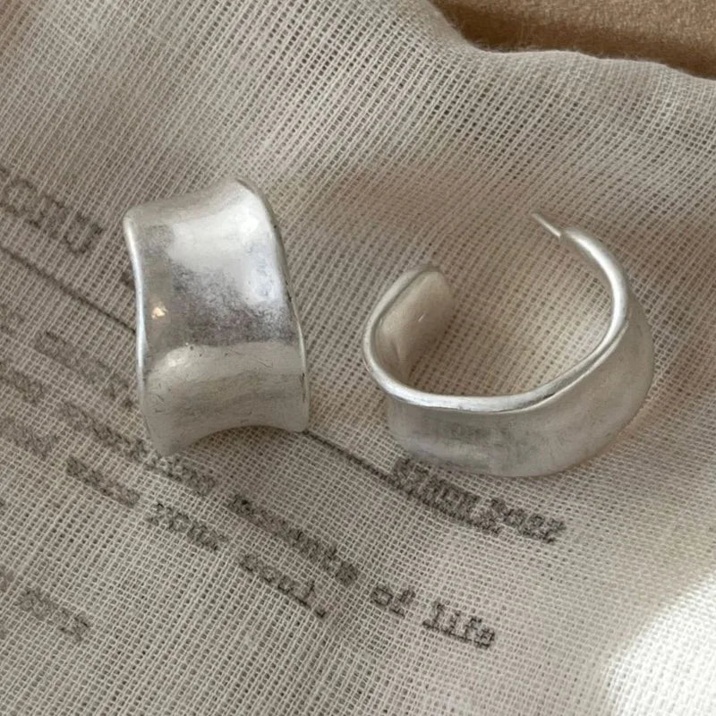 sterling silver hoops on white denim