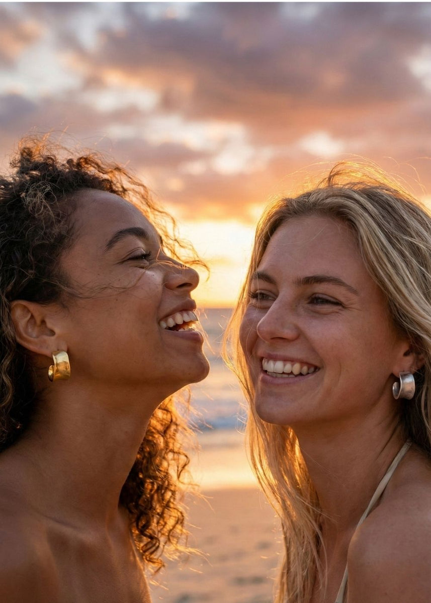 two young models laughing at sunset wearing hoops