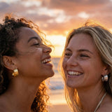 two young models laughing at sunset wearing hoops