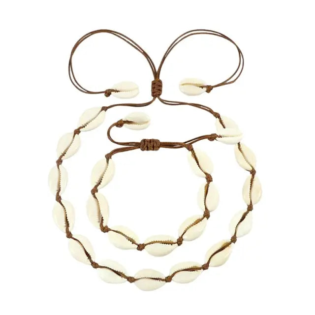 A Cowrie Necklace and Bracelet Set with white and brown cowrie shells linked together on a fine cord with a sliding clasp.