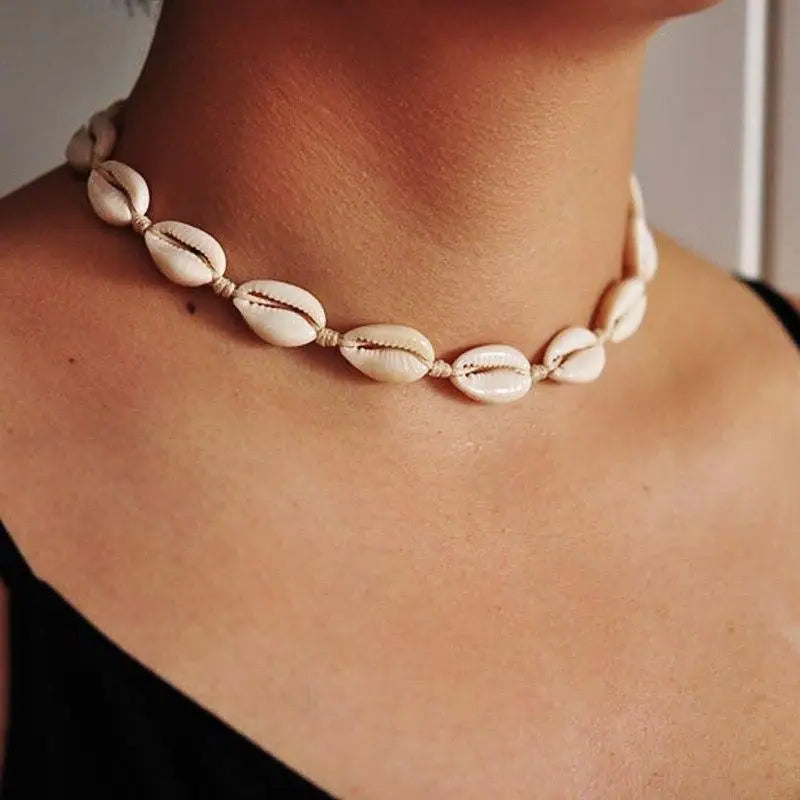 white cowrie necklace on a woman neck