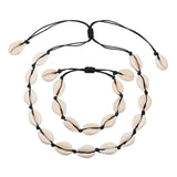A Cowrie Necklace and Bracelet Set with white and brown cowrie shells linked together on a fine cord with a sliding clasp.