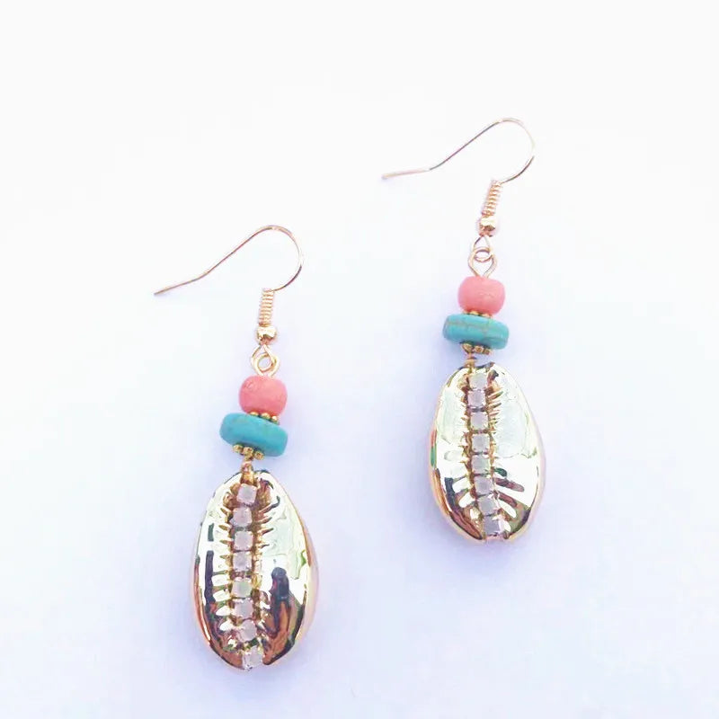 Shell earrings with pink and blue beads on a white background