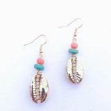 Shell earrings with pink and blue beads on a white background