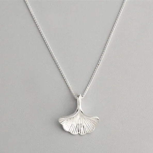sterling Silver seaweed  leaf necklace on a gray background with text