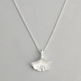 sterling Silver seaweed  leaf necklace on a gray background with text
