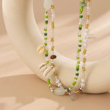 Whispers_of_the_Shoreline_Green_Shell_Belly_Chain_for_Boho_Beach_Days-coastal look-beach style-shell jewerly-
shell earrings-seashell jewelry-coastal jewelry-beach outfit-bohostyle-bohemian outfit
