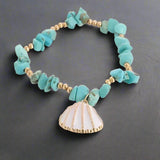 peux tu suspendre cette bague, zoom sur la bague a une branche de bois flotté, sunset, beach