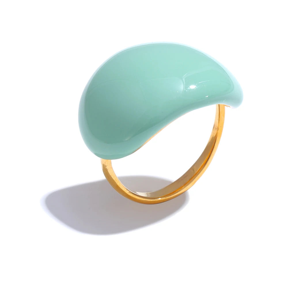 Ring with a green semi-circular stone and gold band on a white background
