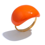 Orange ring with a gold band on a white background