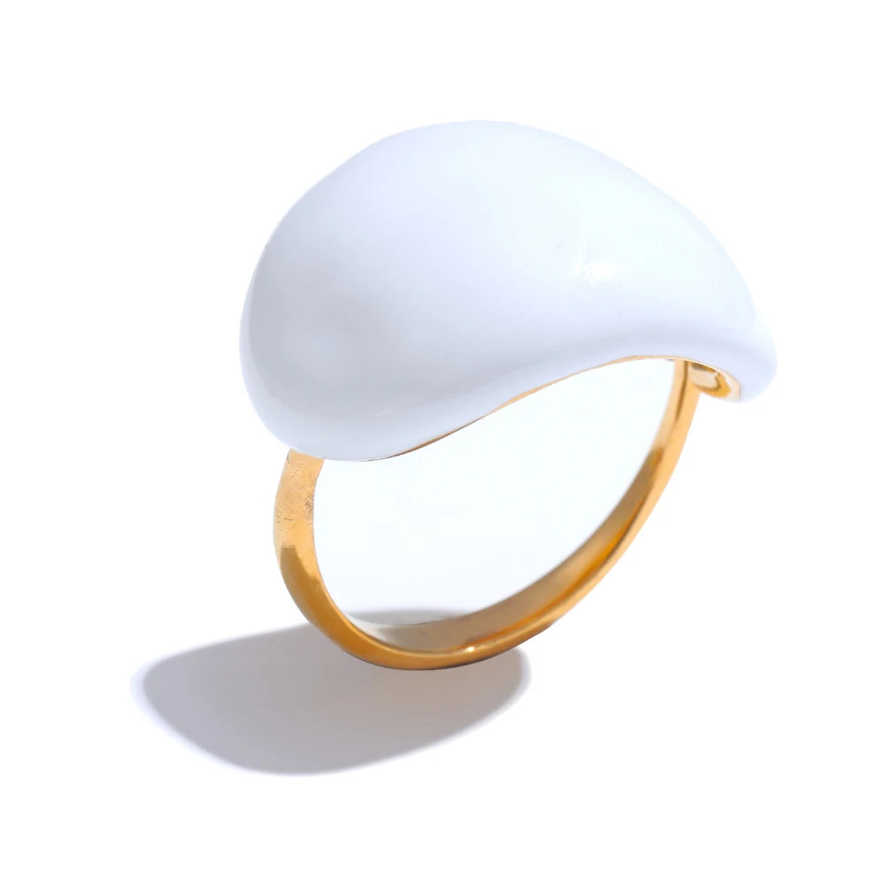 Ring with a white stone and gold band on a white background